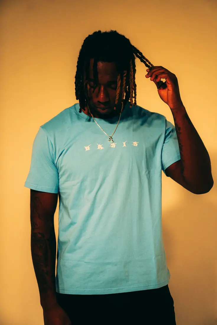 OASIS blue shirt studio portrait
